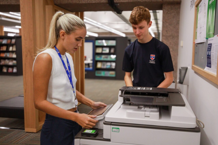 One help desk analyst and one staff member at a printer
